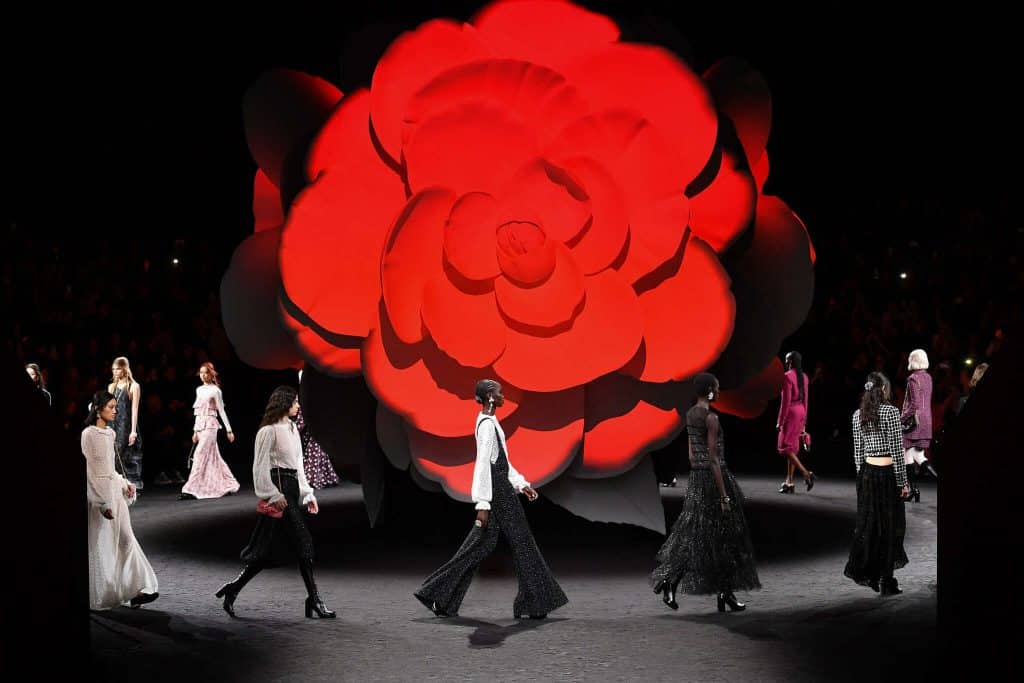 Chanel takes glittering, camellia-themed line-up to Paris catwalk