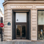 Lanvin boutique facade on rue du Faubourg Saint Honore, gold logo above entrance, classic Paris architecture, luxury fashion store